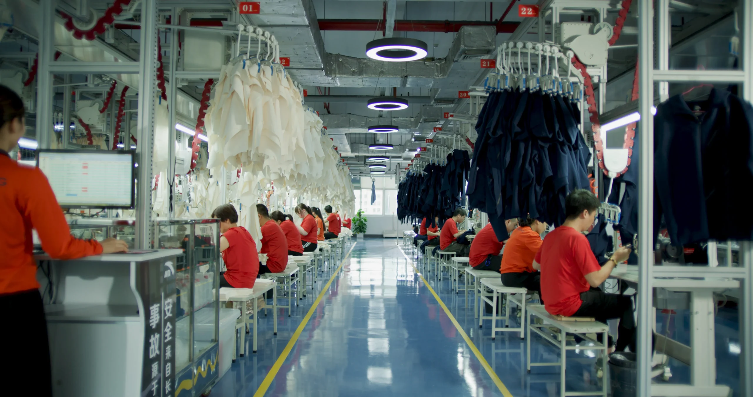 Workers sewing custom garment in China factory