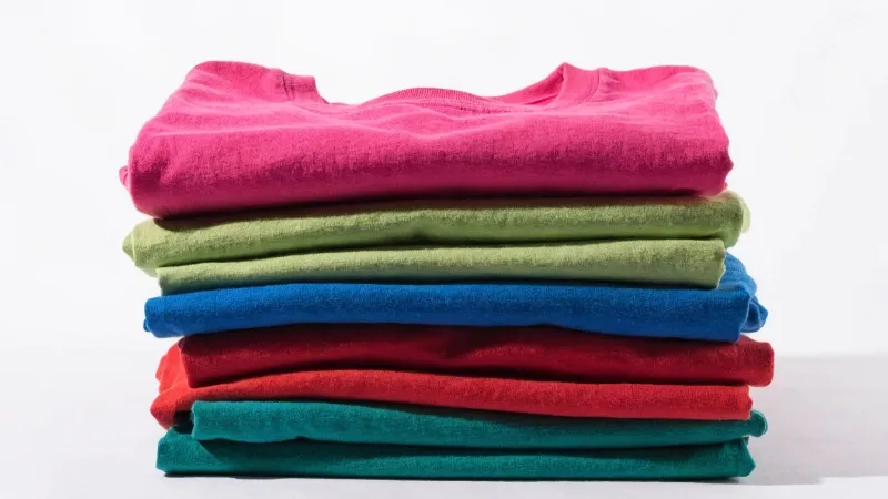 Bright high-impact color T-shirts in pink, lime green, blue, red, and emerald for 2026 shirt trends