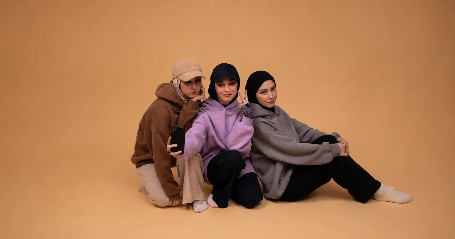 Three women in oversized Hoodie