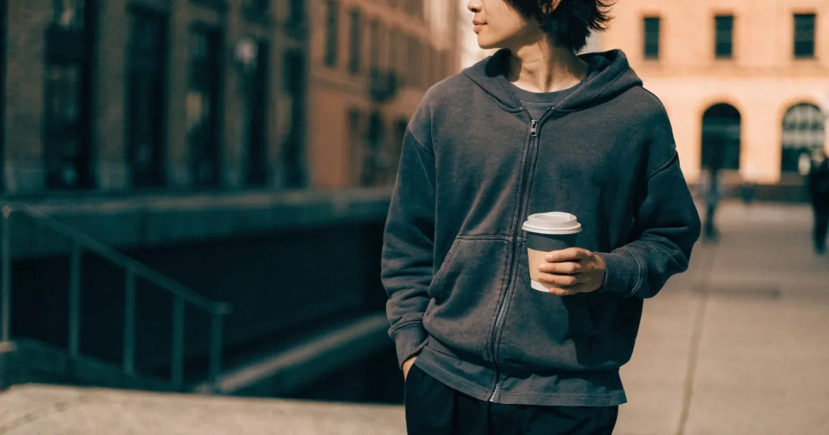 a man is wearing zip-up hoodie