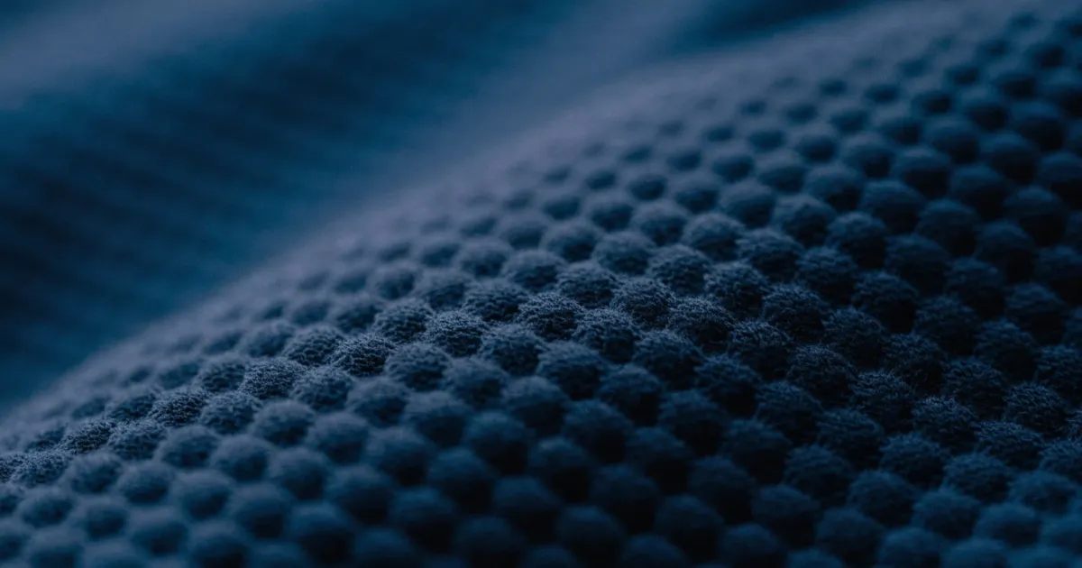 Cotton piqué fabric close-up showing honeycomb texture piqué fabric texture close-up for polo shirts